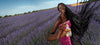 Model in field of lavender holding hair perfume