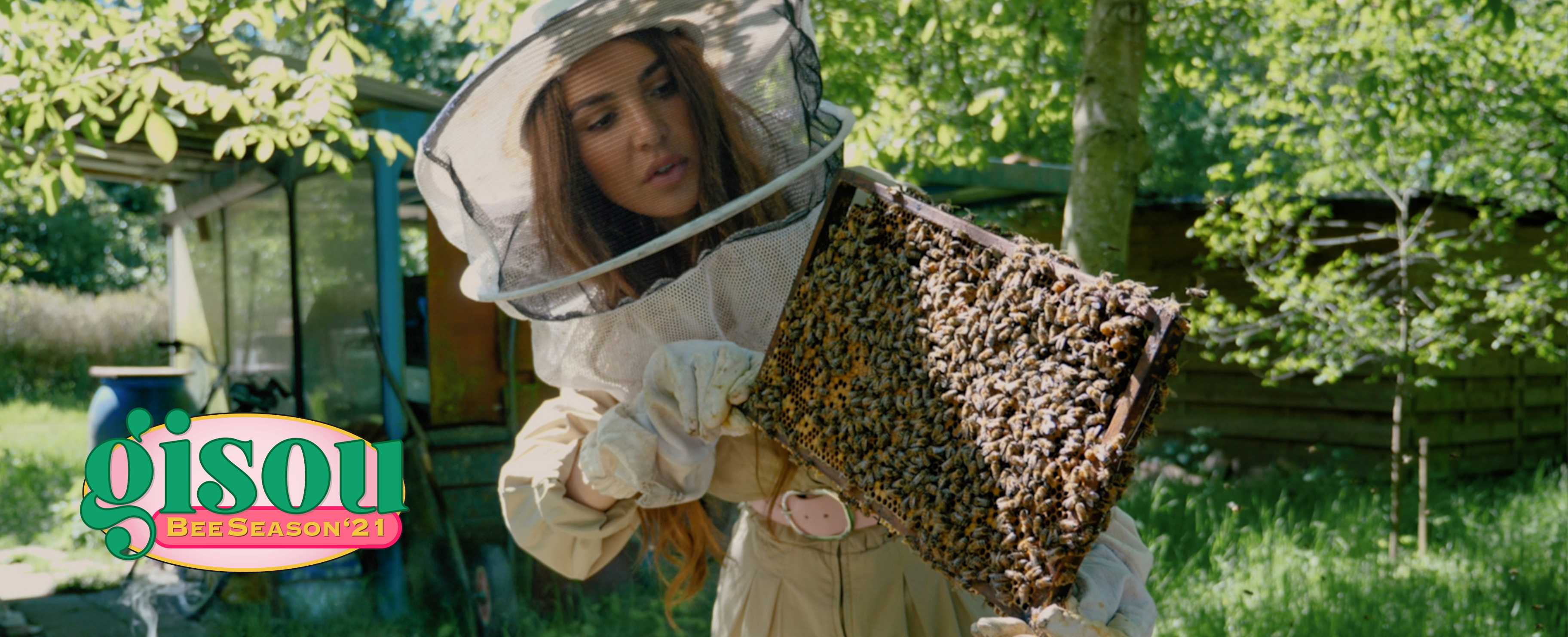 Negin holding a tray of honey bees in the Mirsalehi bee garden