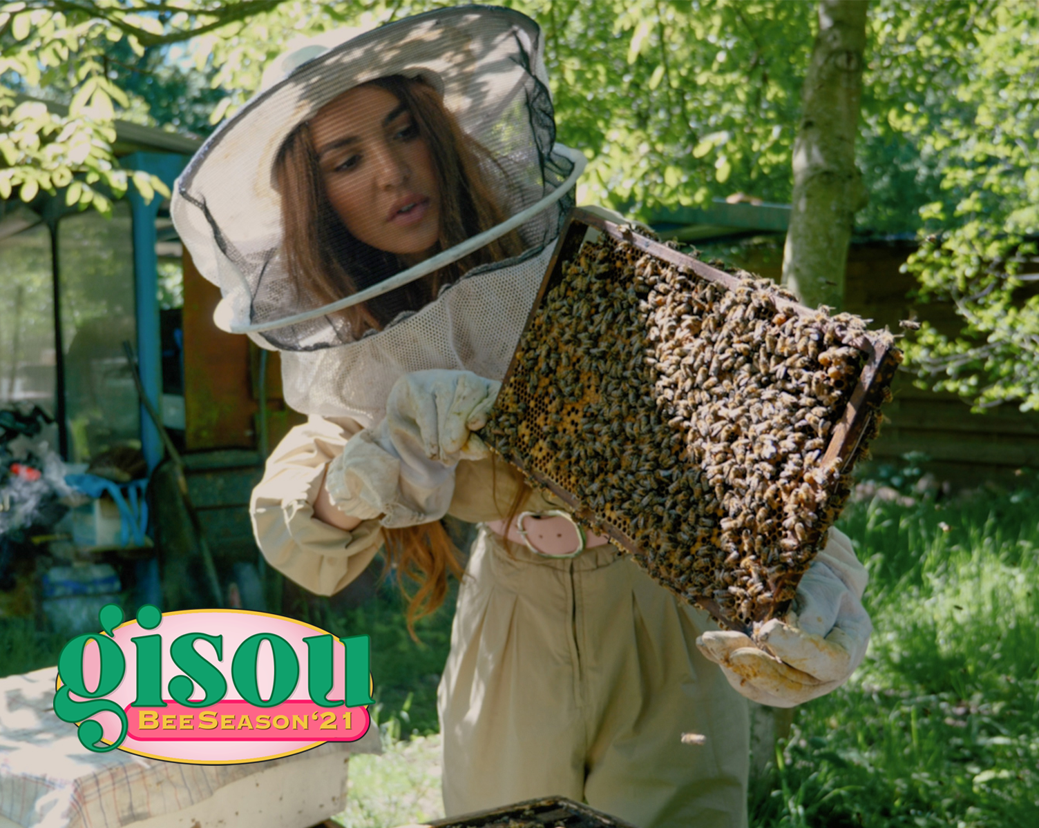 Negin holding a tray of honey bees in the Mirsalehi bee garden