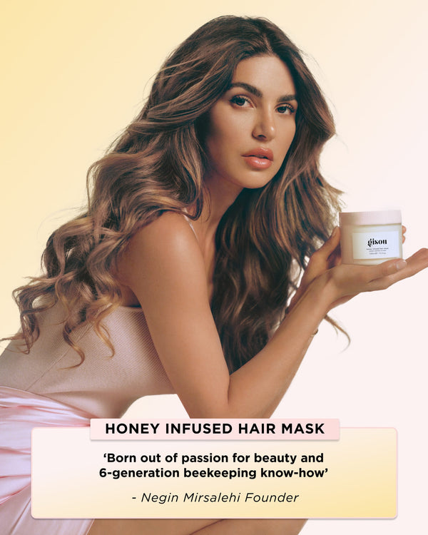 Founder holding a jar of Honey Infused Hair Mask