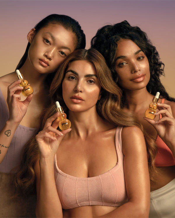 Models and the founder holding bottles of Honey Infused Face Oil