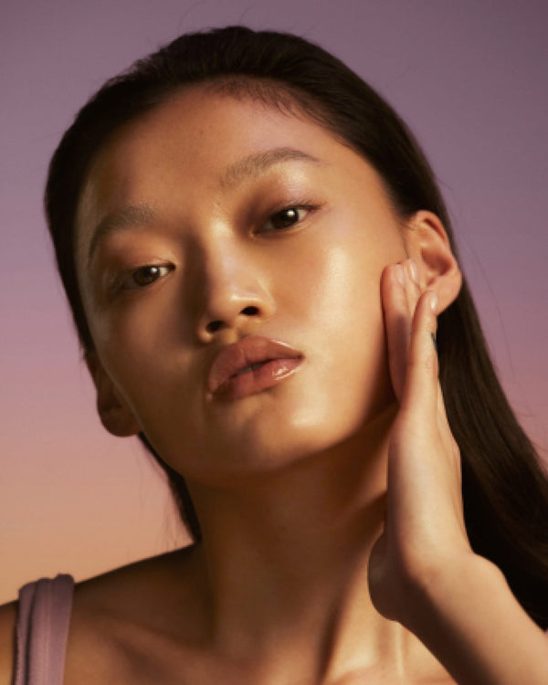 Model showing glowing skin by using the Honey Infused Face Oil